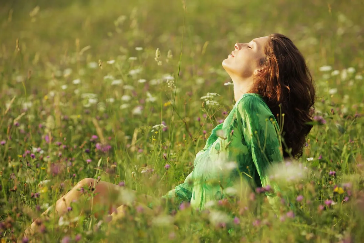 Woman with eyes closed in the field