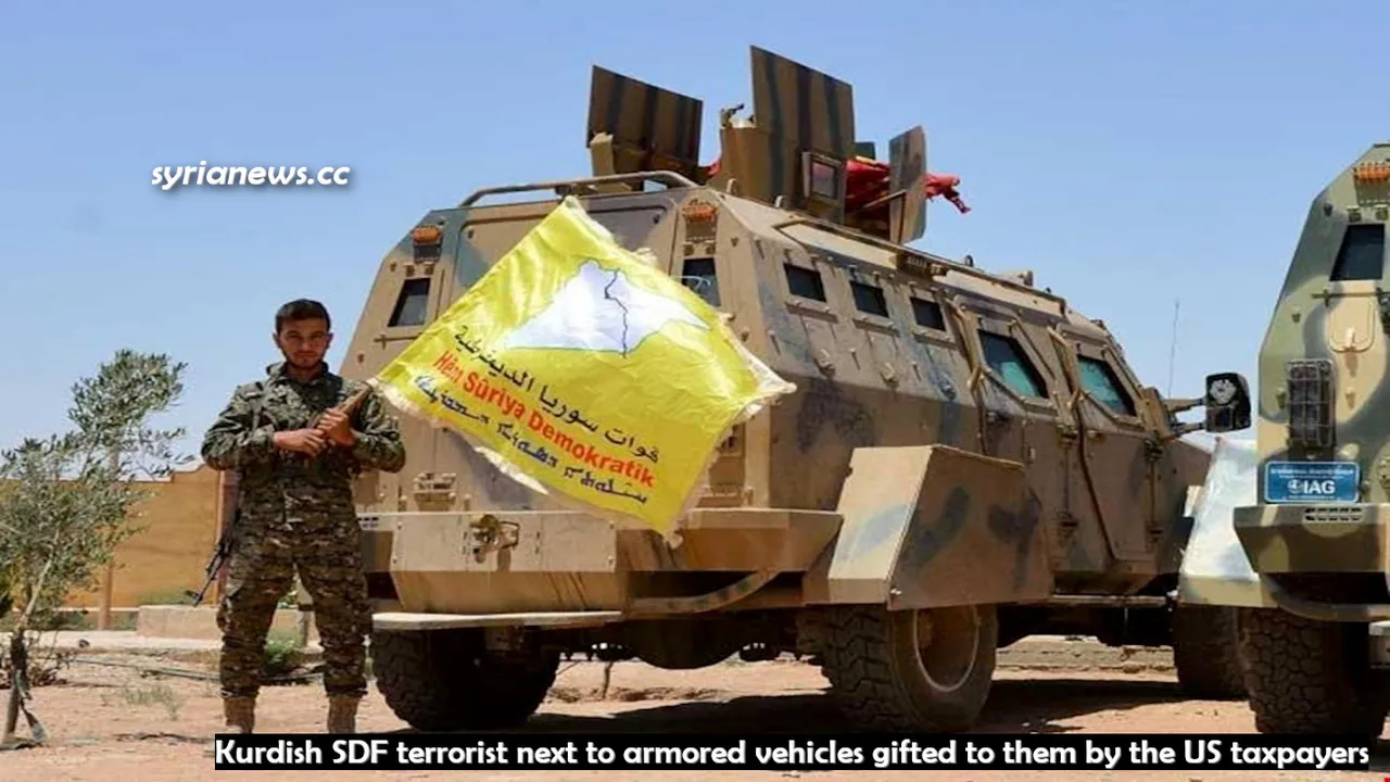 US-sponsored Kurdish SDF terrorist next to armored vehicles gifted to them by US taxpayers.jpg