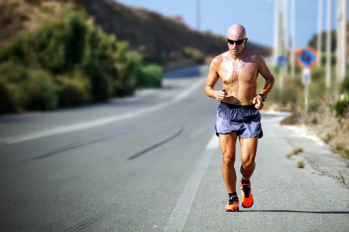 Free Man Running Beside Street Stock Photo