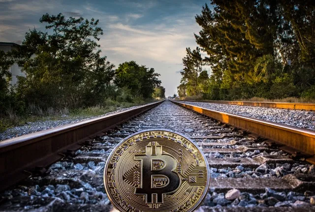 gold-colored-bitcoin-on-railroad-1099296.jpg