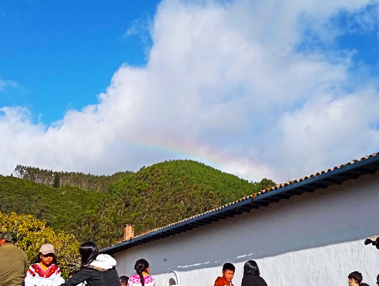 Rainbow time! Not easy to see, but right above the hill in the middle of the picture.