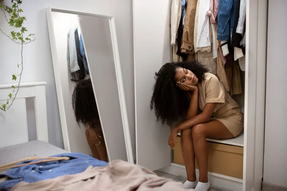 full-shot-sad-woman-closet.jpg