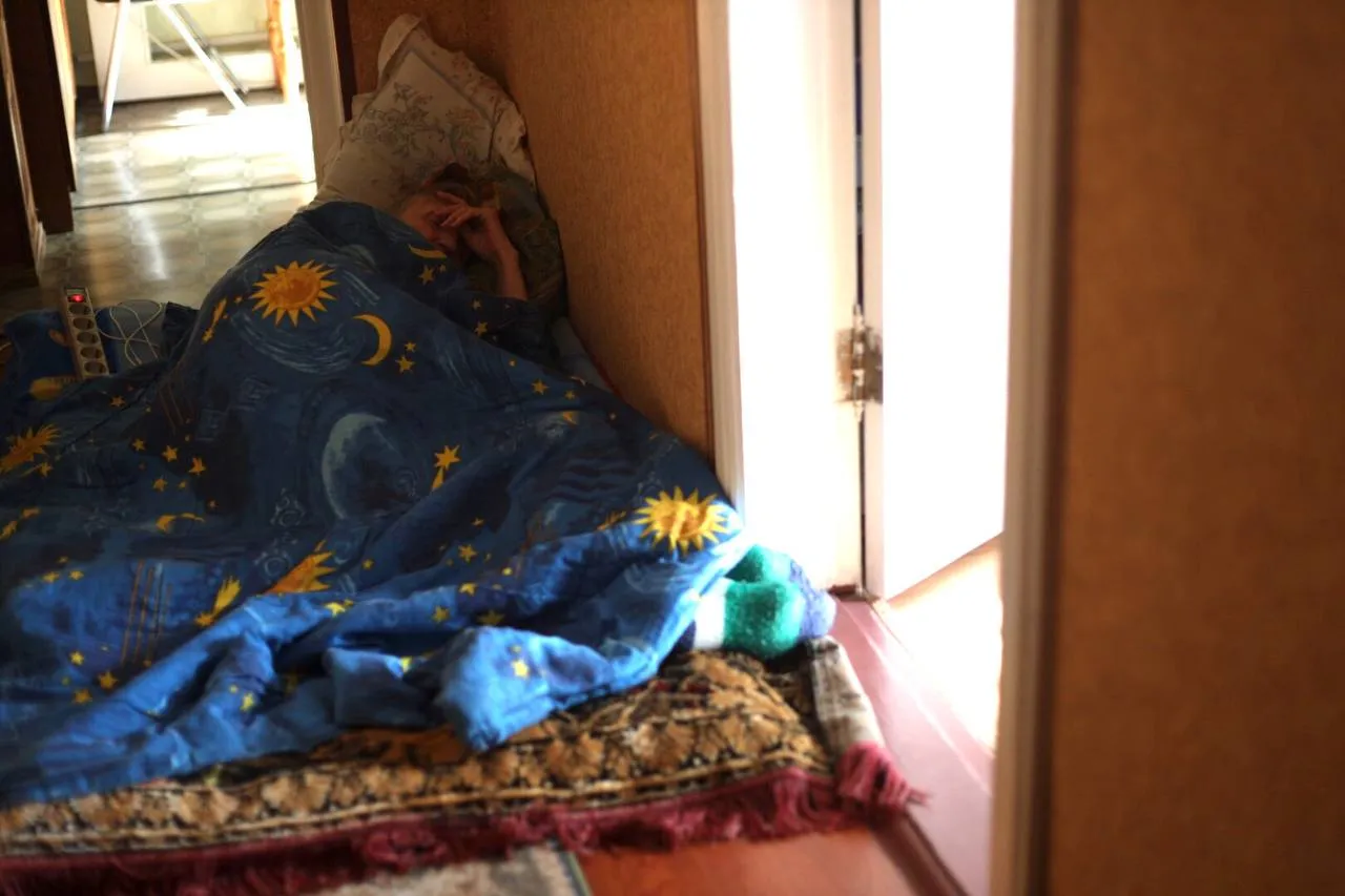 My mother, who is resting in the hallway during an air raid in Kyiv