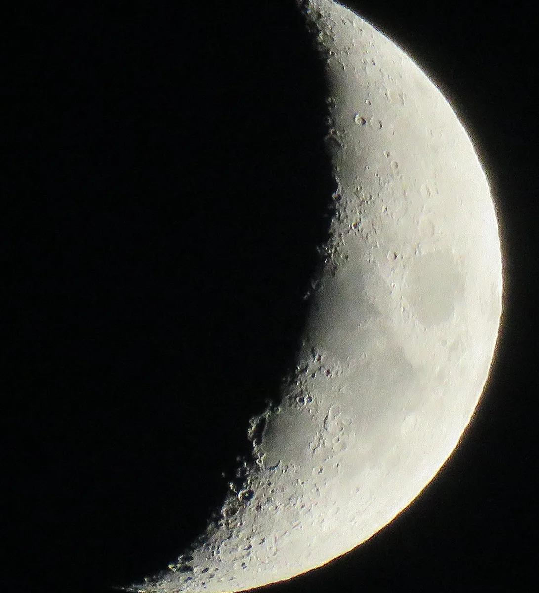 close up cresent moon with details showing on surface.JPG