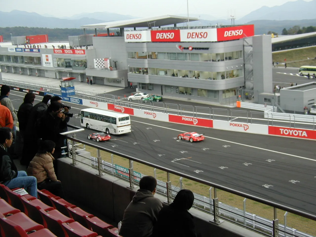 272 - Tour busses racing Super GT cars.  Not really.  The busses had fans inside so that you could "be on track" with the race cars while they thundered by. It seemed like a neat way to experience racing.