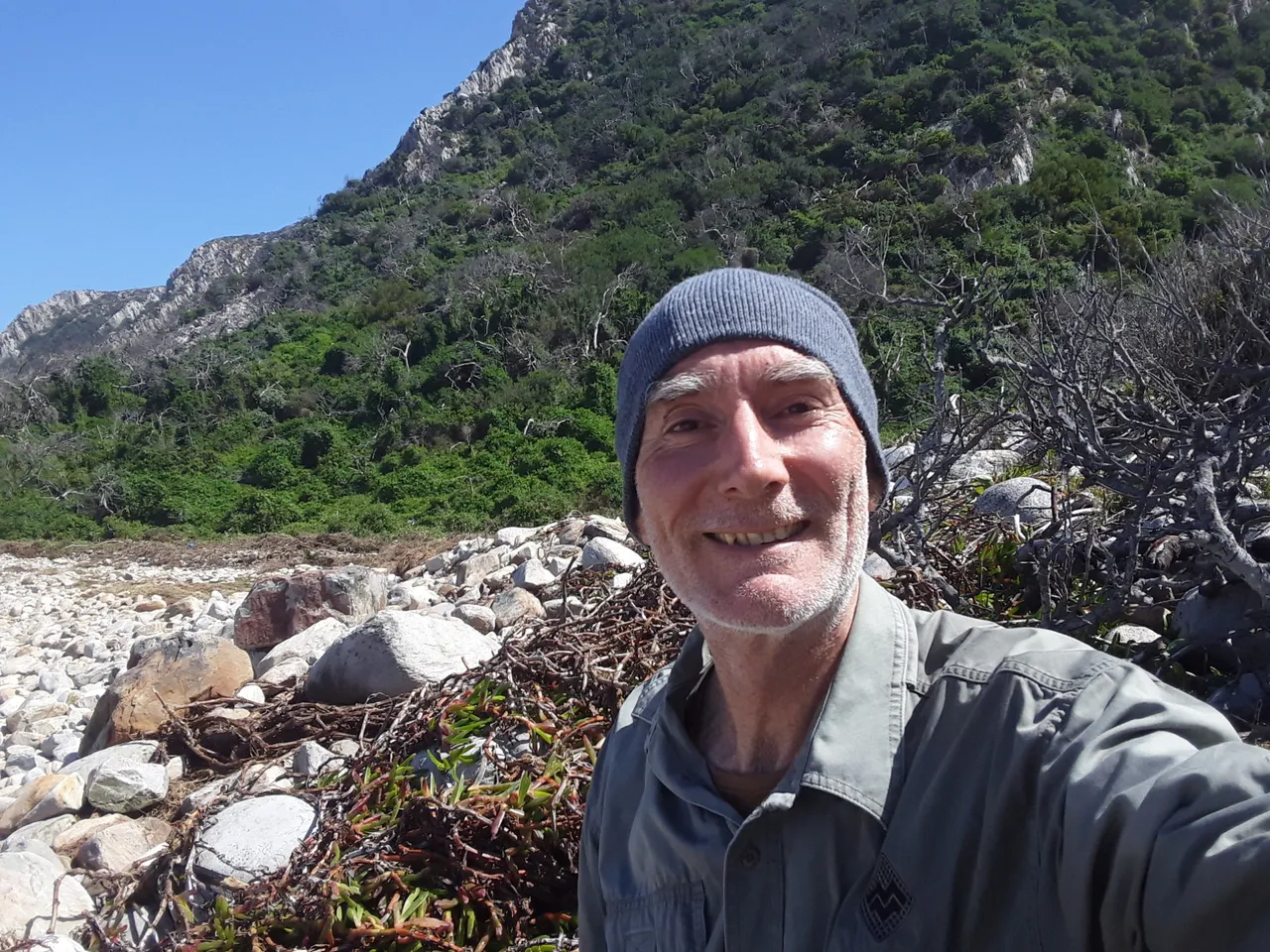 Happy hiker at the shore.