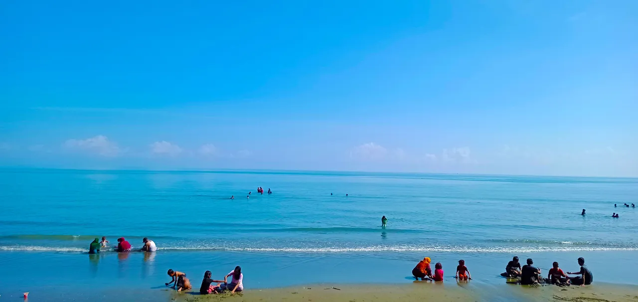 many small children playing on the beach