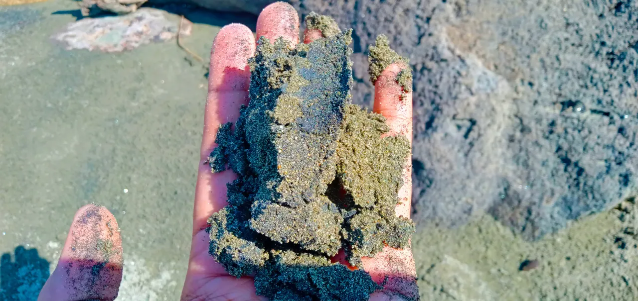 My Hand Holds Black Sand