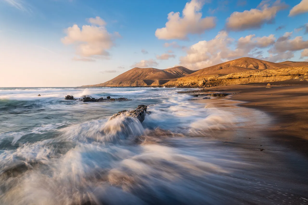 The golden sand and hills at Playa la Solapa