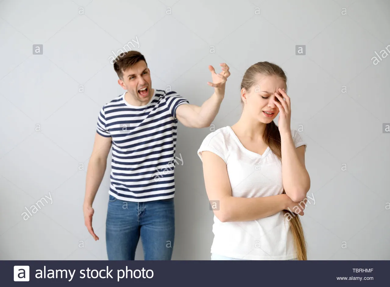 young-quarrelling-couple-on-light-background-TBRHMF.jpg