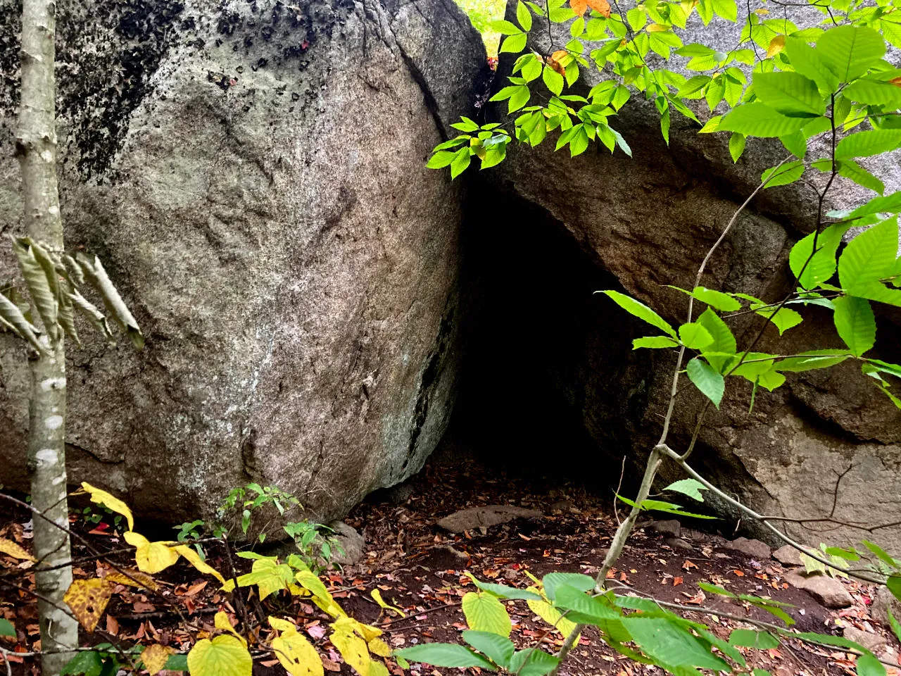 a small cave in the granite rock by the trail