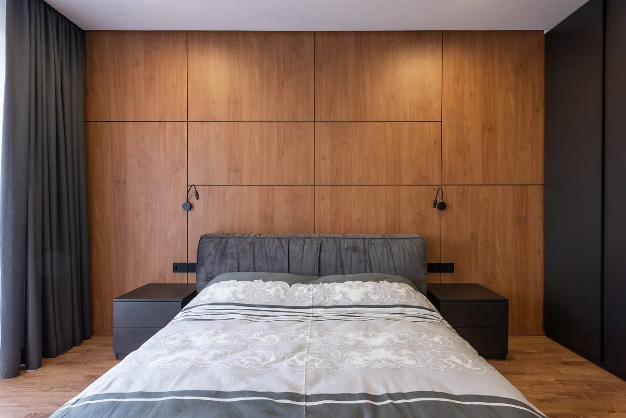 interior of modern bedroom with soft bed and wooden walls