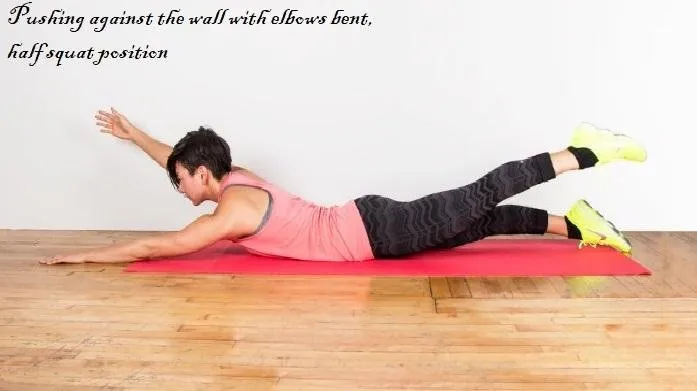 Pushing against the wall with elbows bent, half squat position.jpg