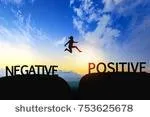 stock-photo-woman-jump-through-the-gap-between-negative-to-positive-on-sunset-753625678.jpg