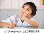 stock-photo-male-student-working-at-desk-in-chinese-school-classroom-116496178.jpg