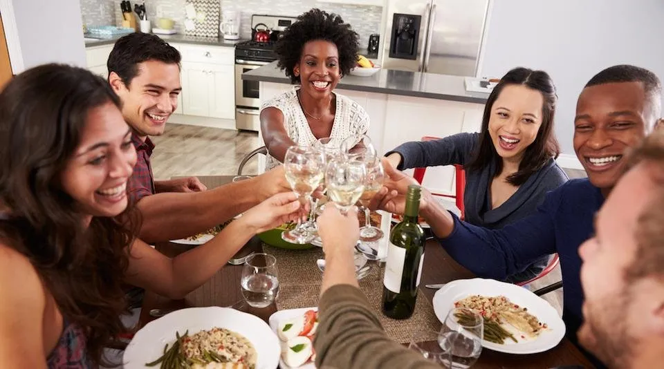 group-of-friends-making-a-toast-at-dinner-party-PPBVF4M.jpg