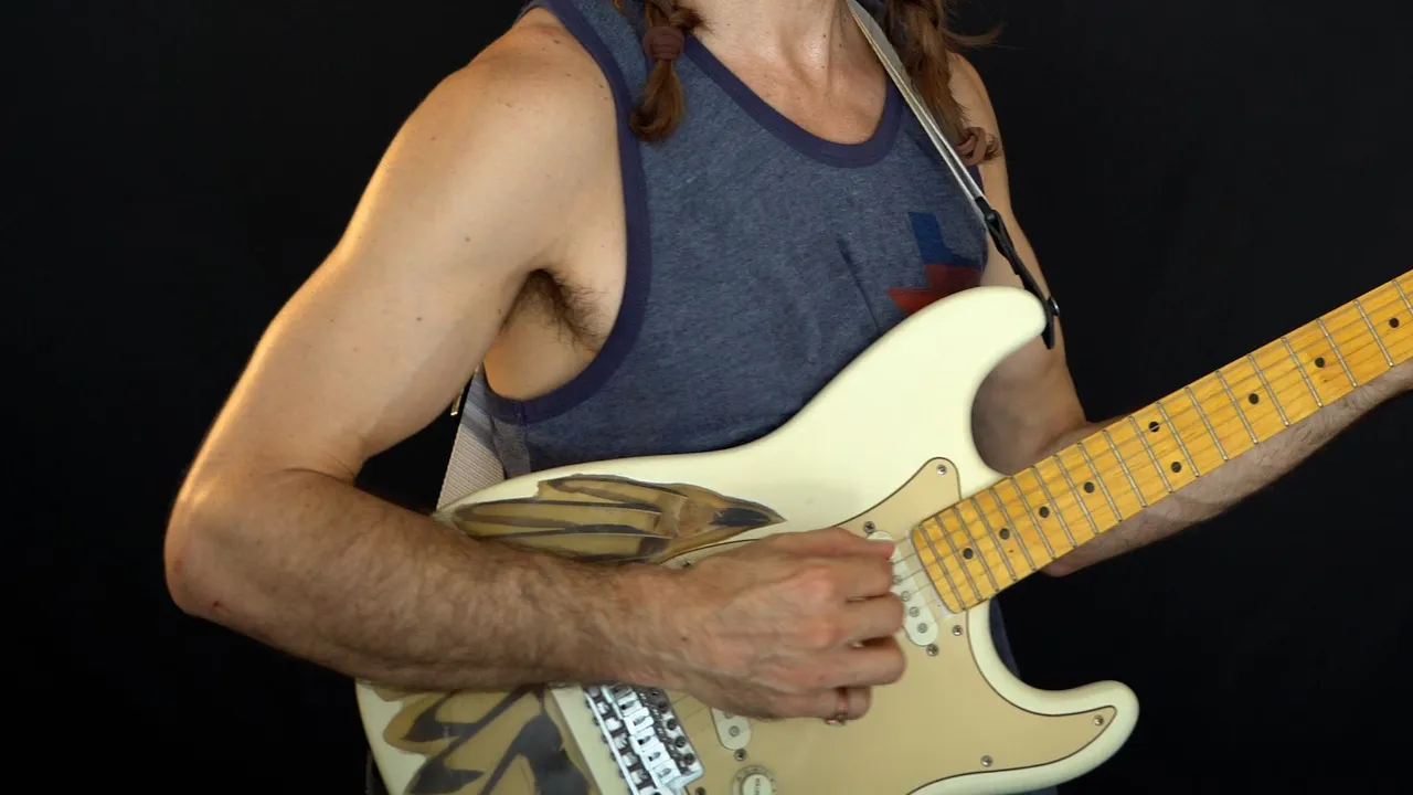 My brother put this guitar together. It's a custom Fender Strat with a magpie bone and feather inlay.