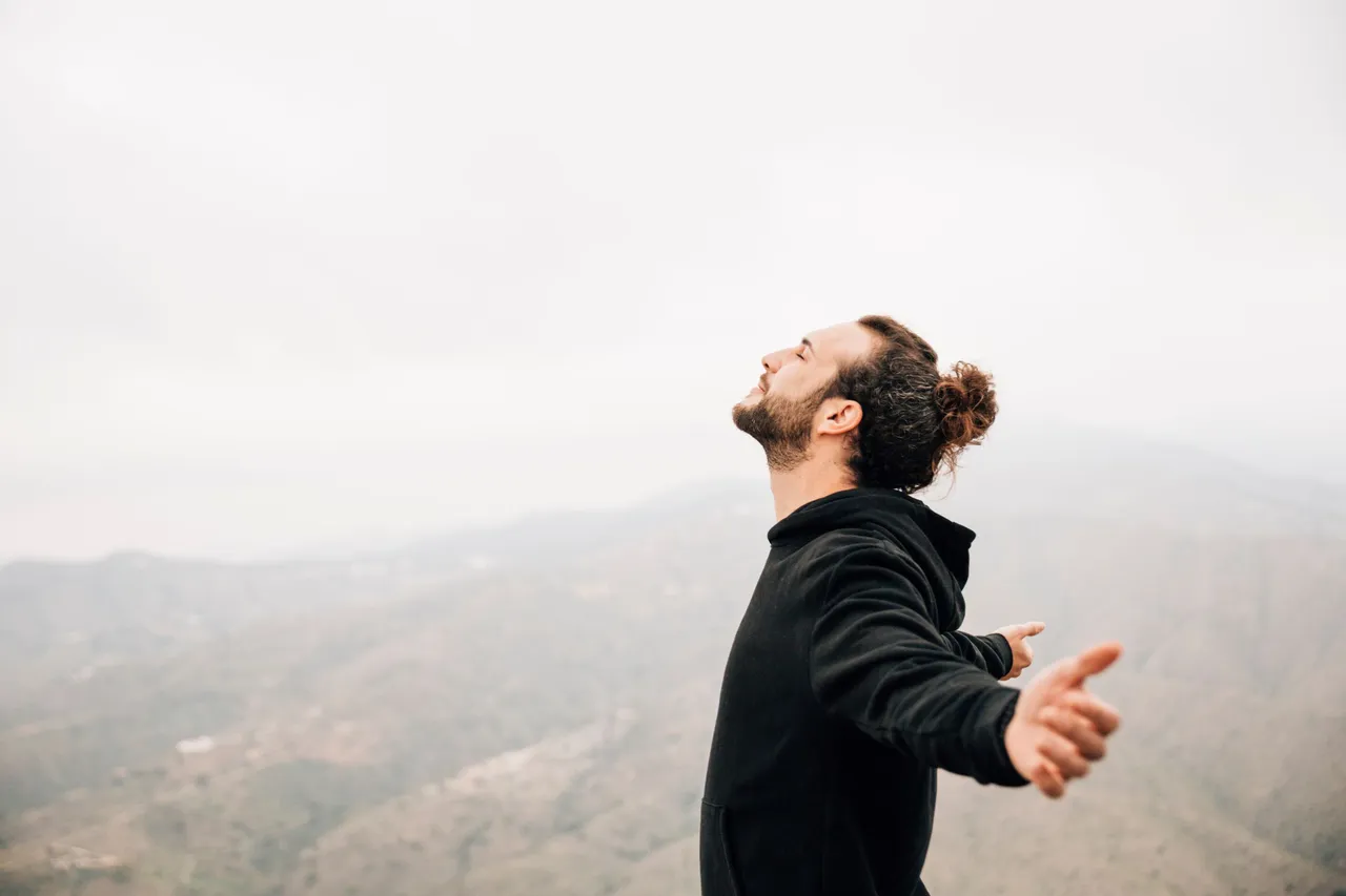 side-view-of-carefree-man-enjoying-freedom-with-arms-outstretched.jpg