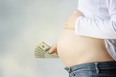 pregnant-woman-hand-holding-dollar-260nw-214083571.jpg copy.jpg