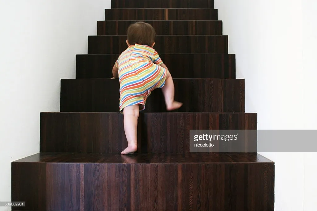 baby-climbing-wooden-stairs-picture-id539662981.jpg