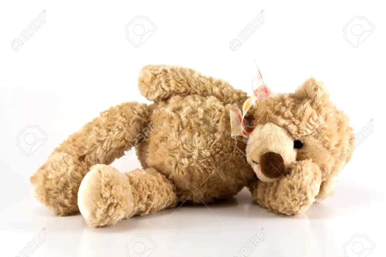 13873371-Cute-furry-brown-teddy-bear-laying-down-sick-holding-his-head-isolated-on-white-background-with-copy-Stock-Photo.jpg