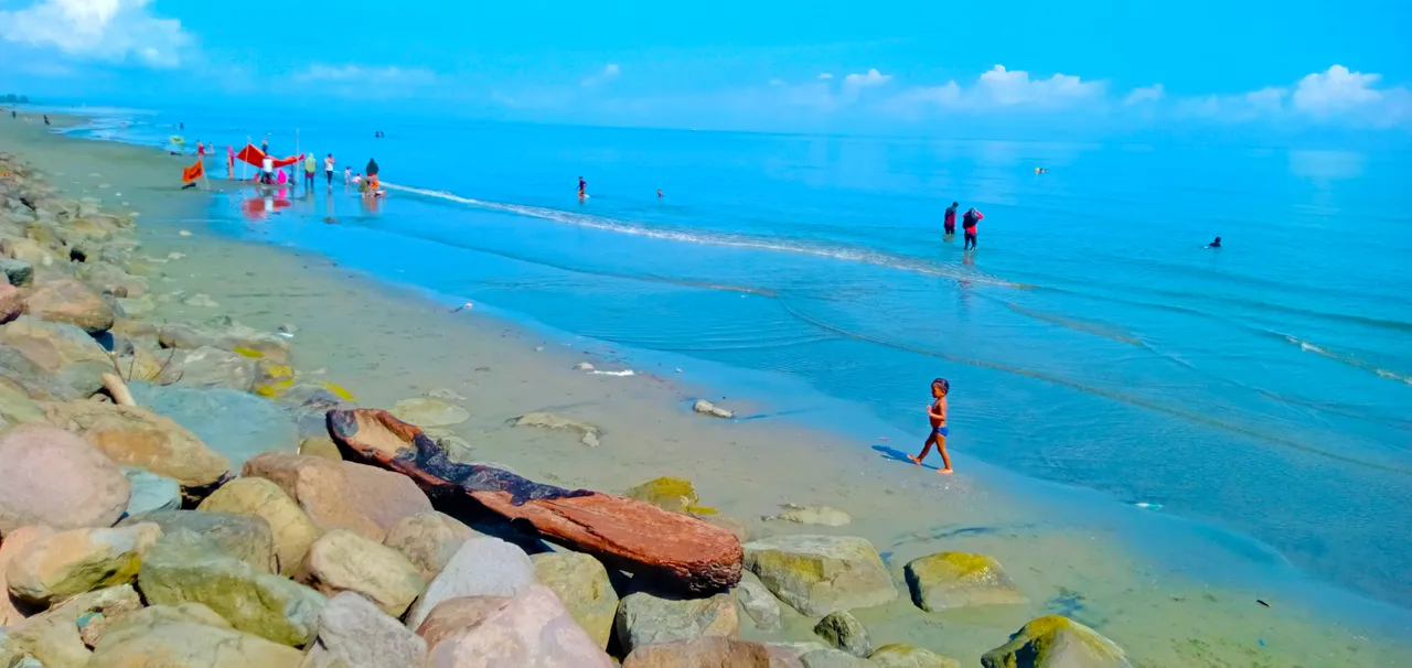 ```Little children and rocks on the beach