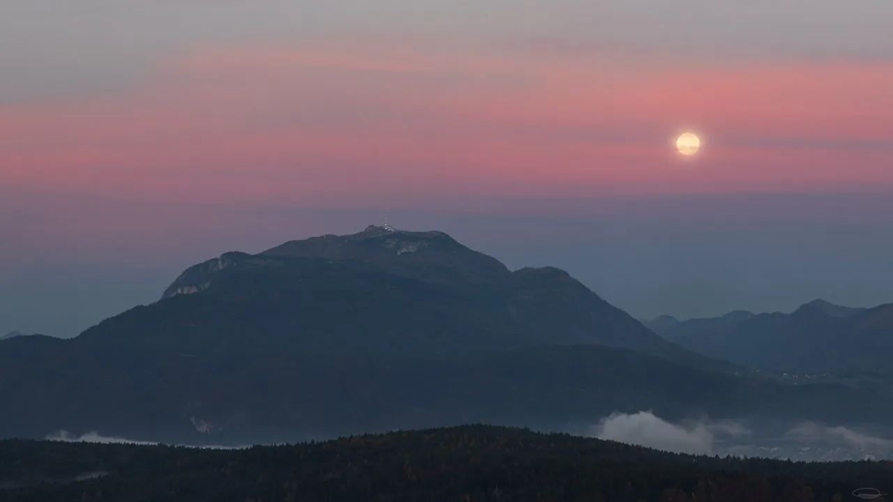 Dobratsch Mountain and Full Moon behind pink Clouds
