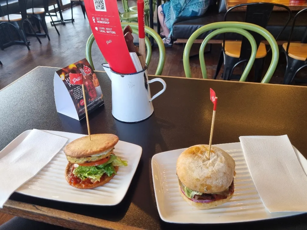 Garden goodness on a gluten free bun on the left and my impossible garden goodness on the right with meat tasting Vegan paddie.