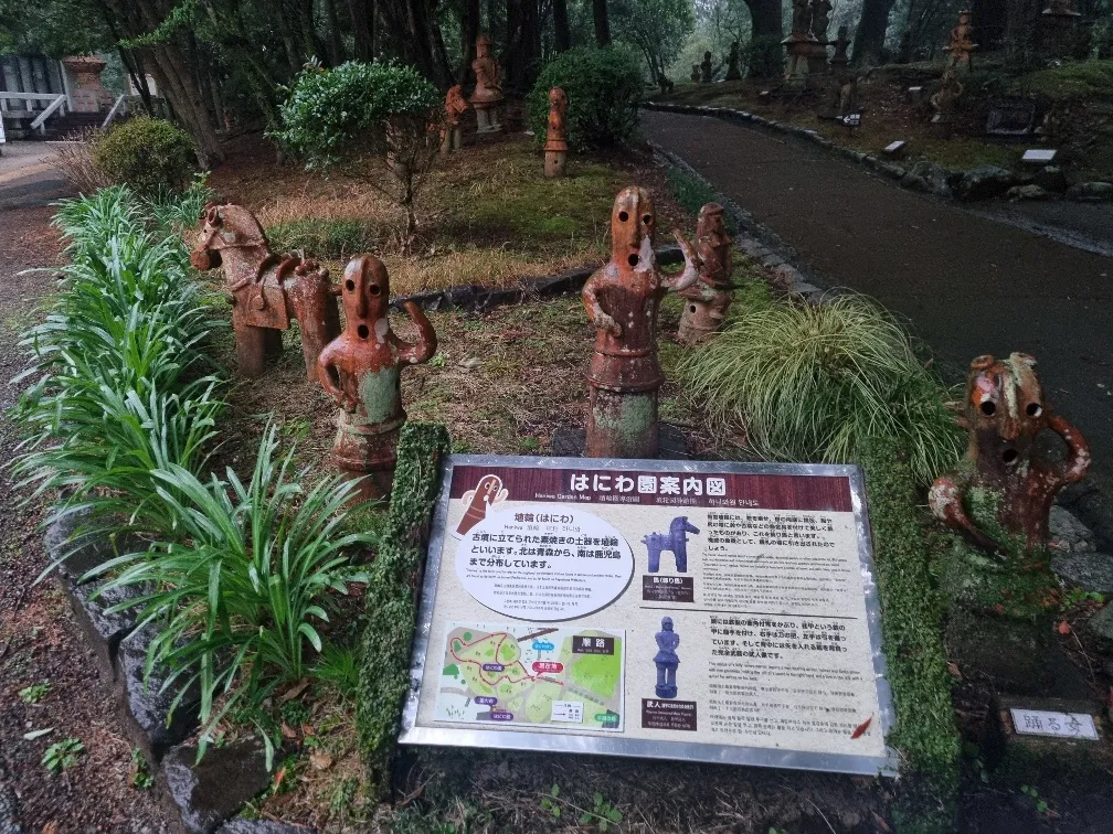 100s of replica earth ware haniwa pottery pieces decorated the garden they were used in olden times on burial mounds.