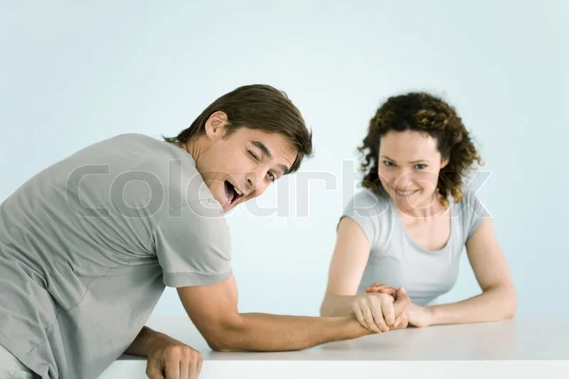 1921077-ale-ventura-altopress-maxppp-couple-arm-wrestling-both-looking-at-camera-man-winking-as-he-lets-woman-win.jpg
