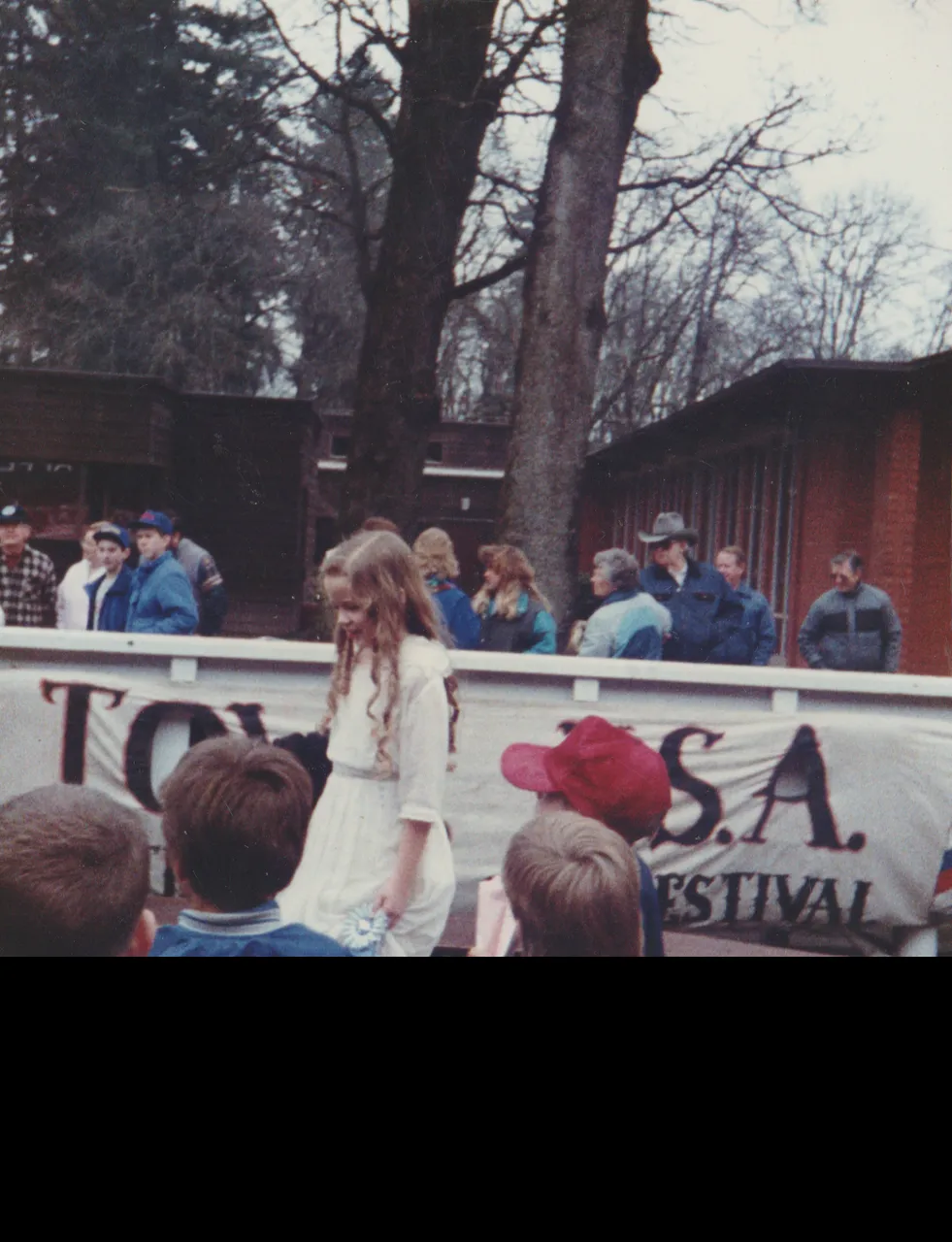 1990s - Crystal or Katie in the 1980s - Looks like Crystal and little bit like Katie, a girl winning a blue ribbon, other random kids ona  stage-3 ok.png