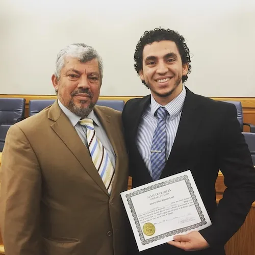 Ali swearing in with dad (1).jpg