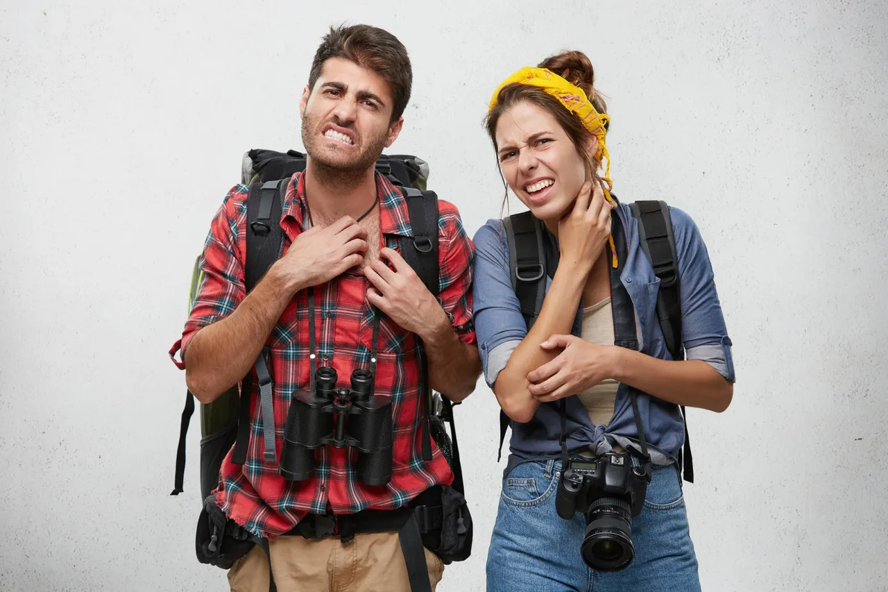 portrait-of-angry-young-couple-scratching-feeling-annoyed-while-being-bitten-by-exotic-insects-or-mosquitos-looking-at-camera-with-painful-expression-on-their-faces-tourism-travel-and-adventure.jpg