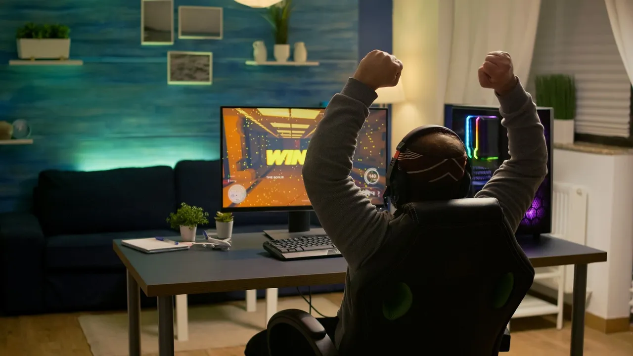 videogamer-player-raising-hands-after-winning-first-person-shooter-competition-wearing-hradphones-professional-pro-gamer-playing-online-video-games-with-new-graphics-powerful-computer.jpg