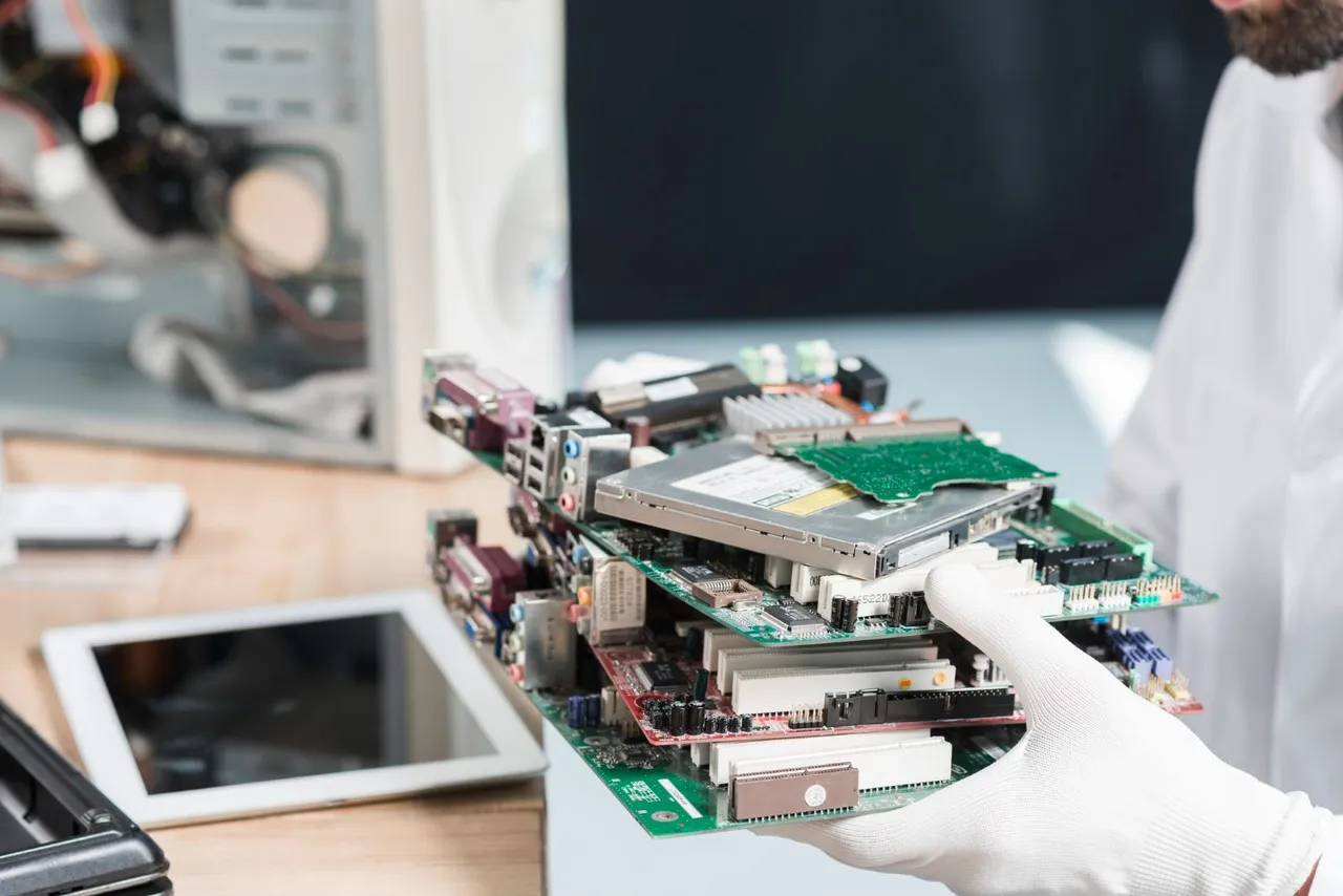 male-technician-hand-wearing-gloves-holding-computer-parts.jpg