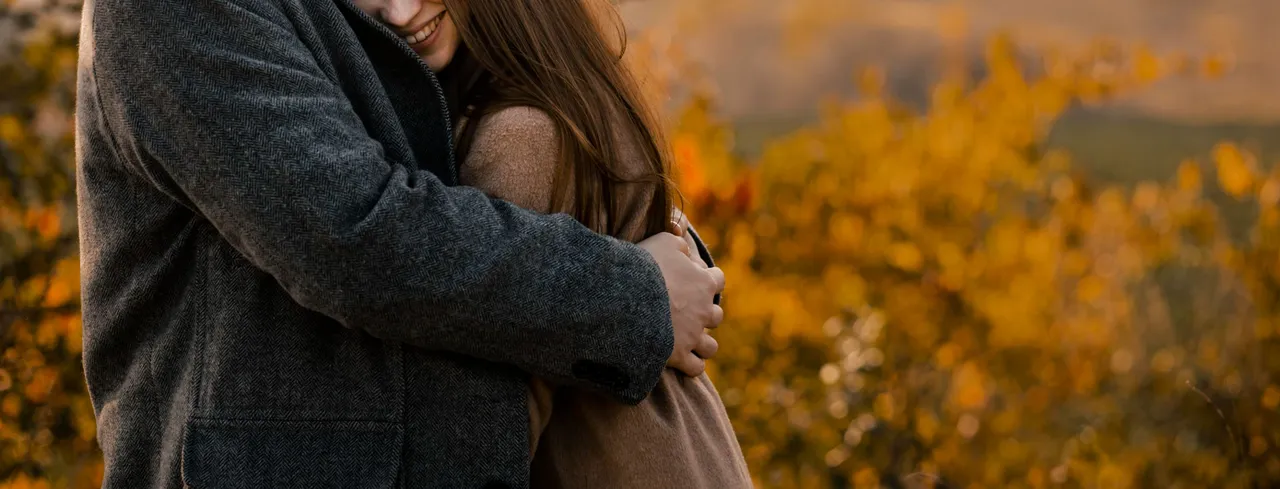 close-up-woman-being-hugged-by-man.jpg