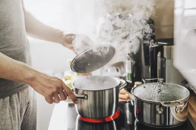 young-man-cooking-fresh-food-home-opening-lid-steaming-pot_1220-5383.jpg