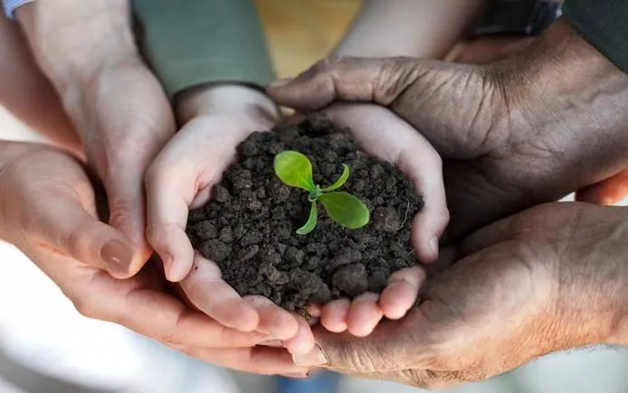 farmers-family-holding-a-fresh-young-plant.jpg