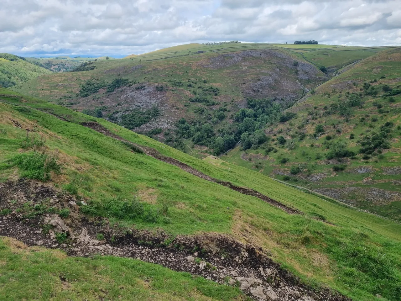 It was very windy on the way up the hill, but calm on the other side going down. We did not have our proper hiking shoes with us but luckily it was not too wet or muddy so there was no slipping and sliding.