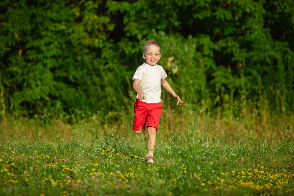 kid_little_boy_running_on_meadow_in_summer_s_sunlight.jpg