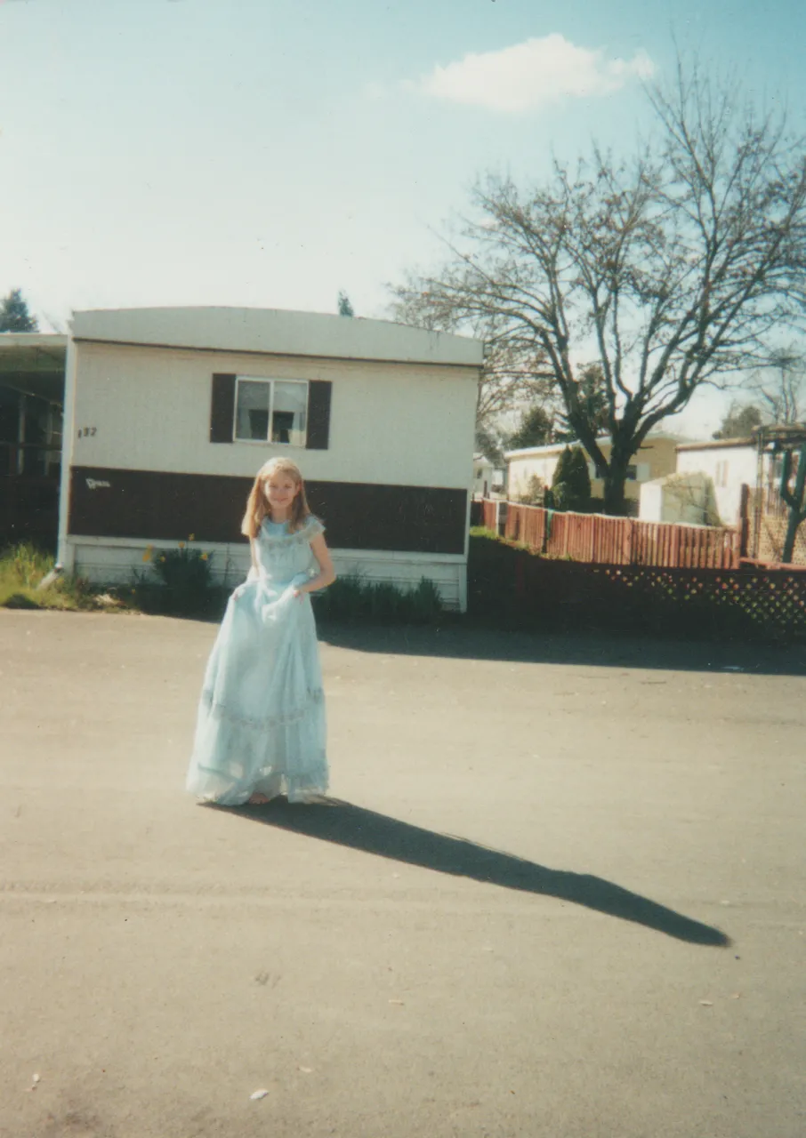 1996 maybe - Savannah in a blue dress in front of our 163 trailer, sunny day.png