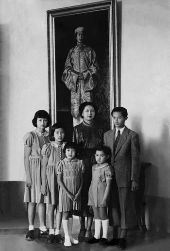 Queen Nam Phuong and her children with a photo of Bao Dai