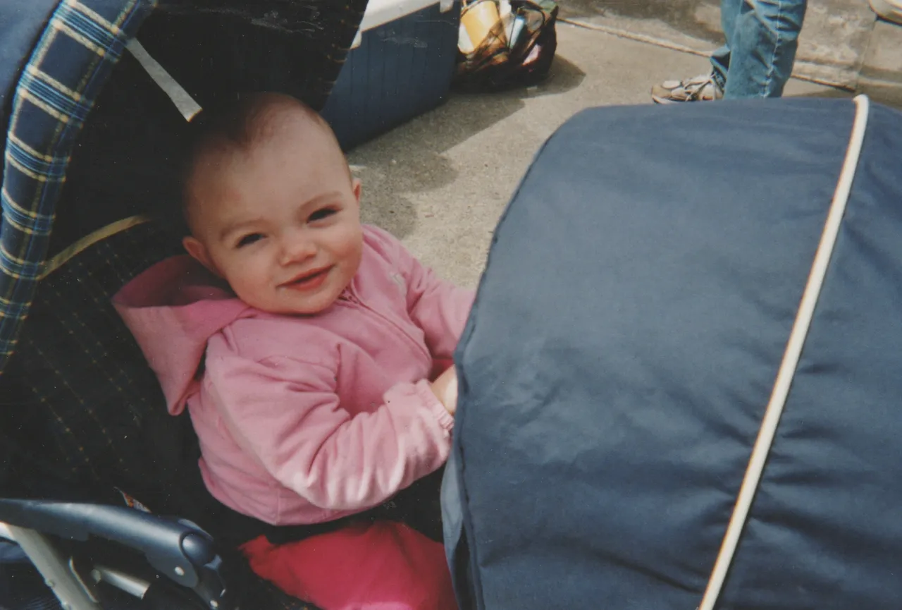 2006-08 - Baby in stroller smiling at the reunion.jpg