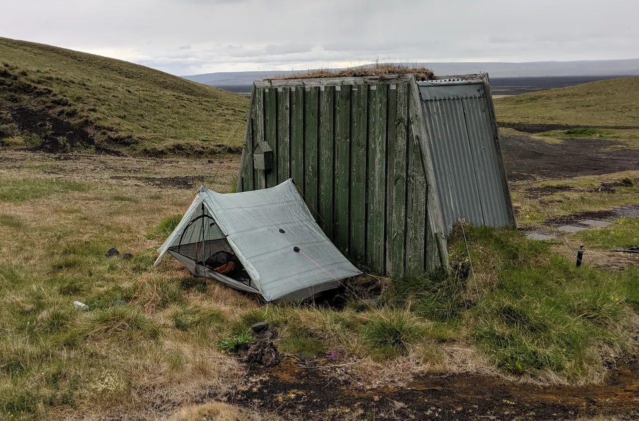 Áfangagil tent site behind outhouse