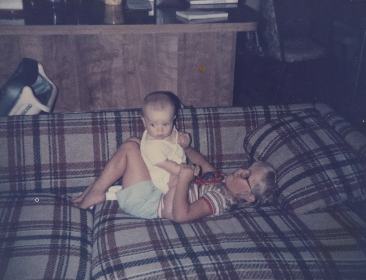 1985 Joey Arnold & Katie 06 Playing But Looking Hey Whats That Over There on Couch.png