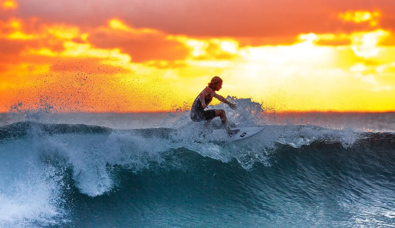 Surfing against the sun set.