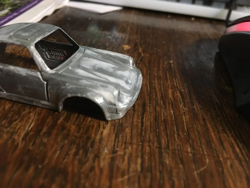 Matchbox Porsche 911 model car stripped to metal