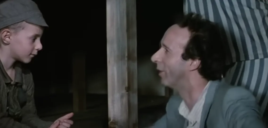 Guido making his son laugh in the camp