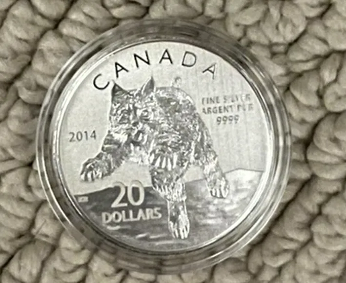 The reverse with the Bobcat, the value of the coin, country, and year.