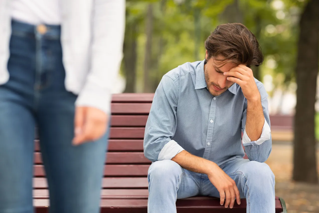 woman-leaves-upset-man-sitting-bench.jpg